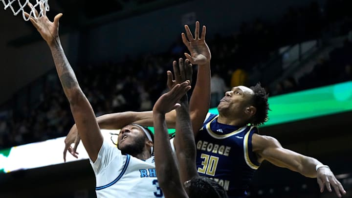 Rams center Javonte Brown gets a shot up around Revolutionaries defender and former PC Friar, Rafael Castro.