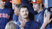 After scoring Houston Astros outfielder Colin Barber is congratulated by teammates in the dugout in the eighth inning against the Washington Nationals at CACTI Park of the Palm Beaches in West Palm Beach, Fla., on Feb. 22, 2025.