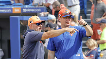 Mar 16, 2025; Port St. Lucie, Florida, USA;  New York Mets manager Carlos Mendoza (right) and Houston Astros manager Joe Espada talk behind the plate after the game at Clover Park. Mandatory Credit: Reinhold Matay-Imagn Images