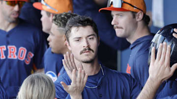 After scoring Houston Astros outfielder Colin Barber is congratulated by teammates in the dugout in the eighth inning against the Washington Nationals at CACTI Park of the Palm Beaches in West Palm Beach, Fla., on Feb. 22, 2025.