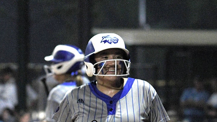 Wellington's Tori Payne smiles coming off the field after scoring a run during Saturday Class 7A state championship victory over Hagerty on May 24, 2025. Wellington's Tori Payne smiles coming off the field after scoring a run during Saturday Class 7A state championship victory over Hagerty on May 24, 2025.