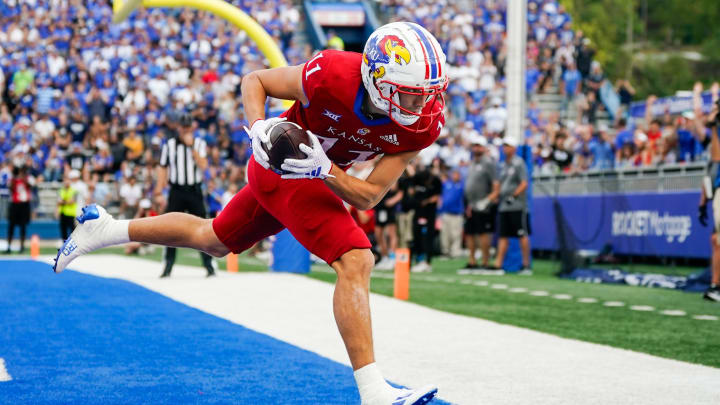 Sep 23, 2023; Lawrence, Kansas, USA; Kansas Jayhawks wide receiver Luke Grimm (11) scores a touchdown during the second half against the Brigham Young Cougars at David Booth Kansas Memorial Stadium.