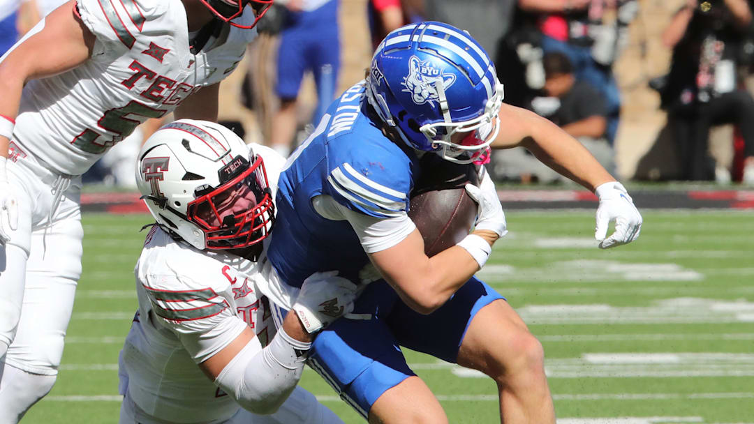 Nov 8, 2025; Lubbock, Texas, USA;  Brigham Young Cougars wide receiver parker Kingston (11) is tackled by Texas Tech Red Raiders defensive back Jacob Rodriguez (10) in the first half at Jones AT&T Stadium. Mandatory Credit: Michael C. Johnson-Imagn Images