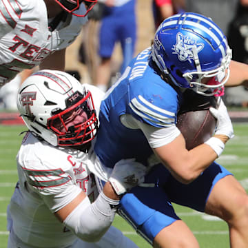 Nov 8, 2025; Lubbock, Texas, USA;  Brigham Young Cougars wide receiver parker Kingston (11) is tackled by Texas Tech Red Raiders defensive back Jacob Rodriguez (10) in the first half at Jones AT&T Stadium. Mandatory Credit: Michael C. Johnson-Imagn Images