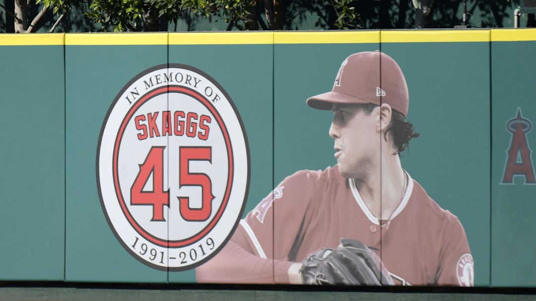 Jul 17, 2019; Anaheim, CA, USA; Detailed view of a memorial for Los Angeles Angels pitcher Tyler Skaggs on the outfield wall  at Angel Stadium of Anaheim. Skaggs, 27, died at a hotel in Southlake, Texas, July 1, 2019, where he was found unresponsive prior to a game against the Texas Rangers. Mandatory Credit: Kirby Lee-Imagn Images