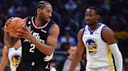 Mar 15, 2023; Los Angeles, California, USA; Los Angeles Clippers forward Kawhi Leonard (2) controls the ball against Golden State Warriors forward Jonathan Kuminga (00) during the first half at Crypto.com Arena. Mandatory Credit: Gary A. Vasquez-Imagn Images