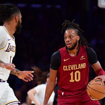 Apr 6, 2024; Los Angeles, California, USA;  Cleveland Cavaliers guard Darius Garland (10) moves the ball against Los Angeles Lakers guard D’Angelo Russell (1) during the first half at Crypto.com Arena. Mandatory Credit: Gary A. Vasquez-Imagn Images