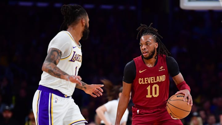 Apr 6, 2024; Los Angeles, California, USA;  Cleveland Cavaliers guard Darius Garland (10) moves the ball against Los Angeles Lakers guard D’Angelo Russell (1) during the first half at Crypto.com Arena. Mandatory Credit: Gary A. Vasquez-Imagn Images