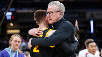 Mar 12, 2025; Indianapolis, IN, USA; Iowa Hawkeyes head coach Fran McCaffery celebrates with guard Brock Harding (2) after defeating the Ohio State Buckeyes at Gainbridge Fieldhouse. Mandatory Credit: Trevor Ruszkowski-Imagn Images