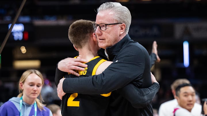 Mar 12, 2025; Indianapolis, IN, USA; Iowa Hawkeyes head coach Fran McCaffery celebrates with guard Brock Harding (2) after defeating the Ohio State Buckeyes at Gainbridge Fieldhouse. Mandatory Credit: Trevor Ruszkowski-Imagn Images