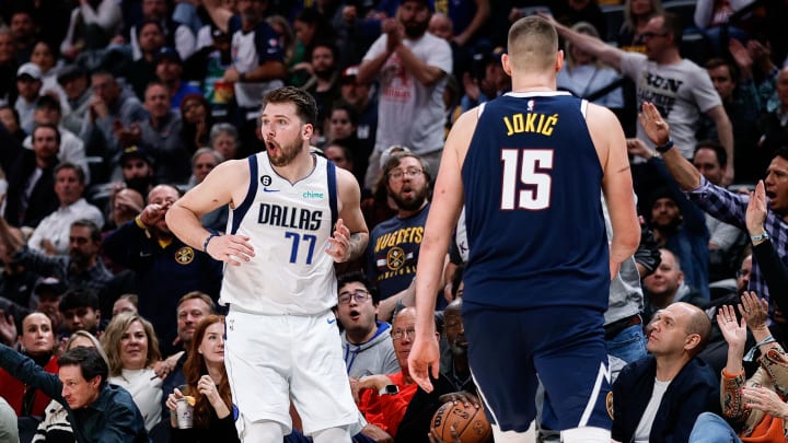 Dec 6, 2022; Denver, Colorado, USA; Dallas Mavericks guard Luka Doncic (77) reacts after a play as Denver Nuggets center Nikola Jokic (15) goes to the side for the ball in the fourth quarter at Ball Arena. Mandatory Credit: Isaiah J. Downing-USA TODAY Sports