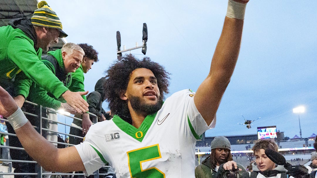 Oregon quarterback Dante Moore celebrates after the game as the Oregon Ducks take on the Washington Huskies on Nov. 29, 2025, at Husky Stadium in Seattle, Washington. Oregon quarterback Dante Moore celebrates after the game as the Oregon Ducks take on the Washington Huskies on Nov. 29, 2025, at Husky Stadium in Seattle, Washington.
