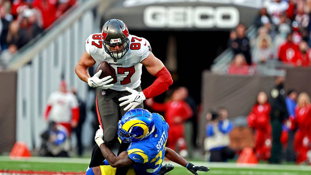Jan 23, 2022; Tampa, Florida, USA; Tampa Bay Buccaneers tight end Rob Gronkowski (87) runs the ball against Los Angeles Rams cornerback Robert Rochell (31) during the second half in a NFC Divisional playoff football game at Raymond James Stadium. Mandatory Credit: Matt Pendleton-USA TODAY Sports