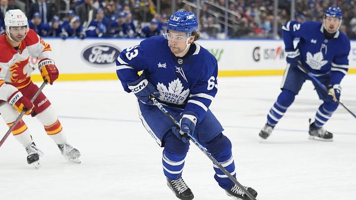 Oct 28, 2025; Toronto, Ontario, CAN; Toronto Maple Leafs forward Matias Maccelli (63) carries the puck against the Calgary Flames during the third period at Scotiabank Arena. Mandatory Credit: John E. Sokolowski-Imagn Images