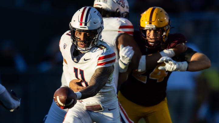 Nov 25, 2023; Tempe, Arizona, USA; Arizona Wildcats quarterback Noah Fifita (11) hands off the ball against the Arizona State Sun Devils in the second half of the Territorial Cup at Mountain America Stadium. 