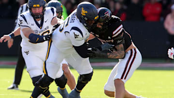 Nov 30, 2024; Lubbock, Texas, USA;  West Virginia Mountaineers offensive lineman Ja’Quay Hubbard (66) blocks Texas Tech Red Raiders Charles Esters III (11) in the first half fat Jones AT&T Stadium and Cody Campbell Field. Mandatory Credit: Michael C. Johnson-Imagn Images
