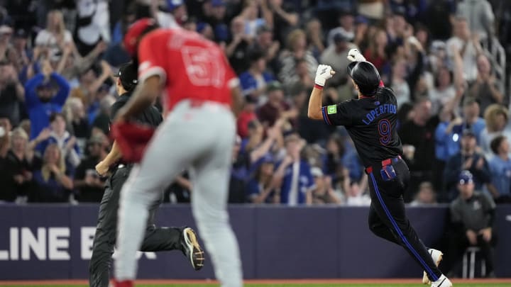 Aug 23, 2024; Toronto, Ontario, CAN; Toronto Blue Jays left fielder Joey Loperfido (9) celebrates as he runs the bases on his solo home run against Los Angeles Angels pitcher Roansy Contreras (57) during the ninth inning at Rogers Centre. Mandatory Credit: John E. Sokolowski-USA TODAY Sports