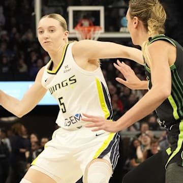 May 21, 2025; Minneapolis, Minnesota, USA; Dallas Wings guard Paige Bueckers (5) passes against Minnesota Lynx forward Alanna Smith (8) in the second quarter at Target Center. Mandatory Credit: Bruce Kluckhohn-Imagn Images