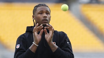 Dec 23, 2023; Pittsburgh, Pennsylvania, USA;  Cincinnati Bengals wide receiver Tee Higgins (5) warms up with tennis balls before the game against the Pittsburgh Steelers at Acrisure Stadium. Mandatory Credit: Charles LeClaire-Imagn Images