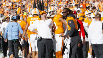 Jan 1, 2024; Orlando, FL, USA; Tennessee Volunteers head coach Josh Heupel, quarterback Nico Iamaleava (8) and quarterback Joe Milton III (7) talk against the Iowa Hawkeyes during the third quarter at Camping World Stadium. Mandatory Credit: Morgan Tencza-USA TODAY Sports