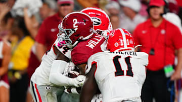 Sep 28, 2024; Tuscaloosa, Alabama, USA;  Alabama Crimson Tide wide receiver Ryan Williams (2) is tackled by Georgia Bulldogs defensive back Malaki Starks (24) and linebacker Jalon Walker (11) during the third quarter at Bryant-Denny Stadium. Mandatory Credit: John David Mercer-Imagn Images