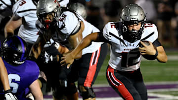 Thompson quarterback Trent Seaborn (12) runs the ball against Lipscomb Academy during an high school football game Thursday, Aug. 29, 2024, in Nashville, Tenn.