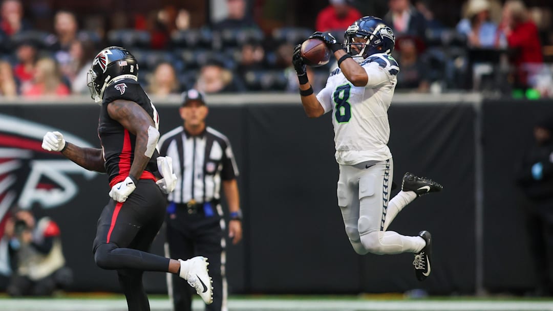 Oct 20, 2024; Atlanta, Georgia, USA; Seattle Seahawks cornerback Coby Bryant (8) intercepts a pass intended for Atlanta Falcons tight end Kyle Pitts (8) in the fourth quarter at Mercedes-Benz Stadium.