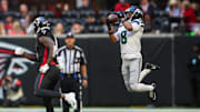 Oct 20, 2024; Atlanta, Georgia, USA; Seattle Seahawks cornerback Coby Bryant (8) intercepts a pass intended for Atlanta Falcons tight end Kyle Pitts (8) in the fourth quarter at Mercedes-Benz Stadium.
