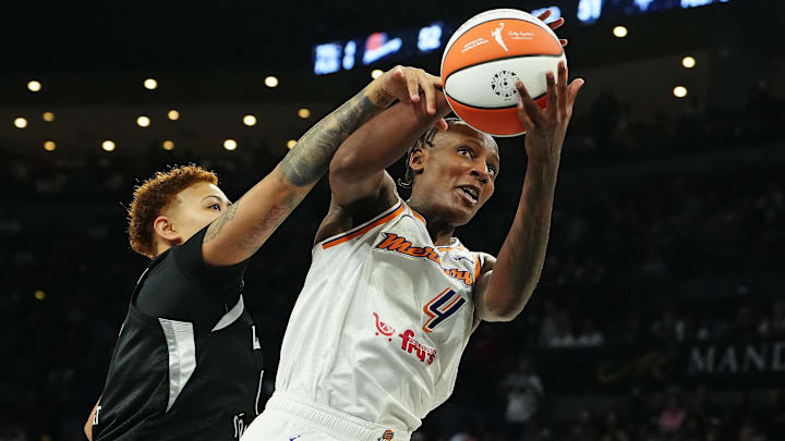 Oct 3, 2025; Las Vegas, Nevada, USA; Phoenix Mercury forward Natasha Mack (4) grabs a rebound in front of Las Vegas Aces forward Kierstan Bell (1) during the third quarter of game one of the 2025 WNBA Finals at Michelob Ultra Arena. Mandatory Credit: Stephen R. Sylvanie-Imagn Images Oct 3, 2025; Las Vegas, Nevada, USA; Phoenix Mercury forward Natasha Mack (4) grabs a rebound in front of Las Vegas Aces forward Kierstan Bell (1) during the third quarter of game one of the 2025 WNBA Finals at Michelob Ultra Arena. Mandatory Credit: Stephen R. Sylvanie-Imagn Images