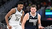 Nov 27, 2022; Milwaukee, Wisconsin, USA; Dallas Mavericks guard Luka Doncic (77) dribbles the ball up court against Milwaukee Bucks forward Giannis Antetokounmpo (34) in the second half at Fiserv Forum. Mandatory Credit: Michael McLoone-Imagn Images