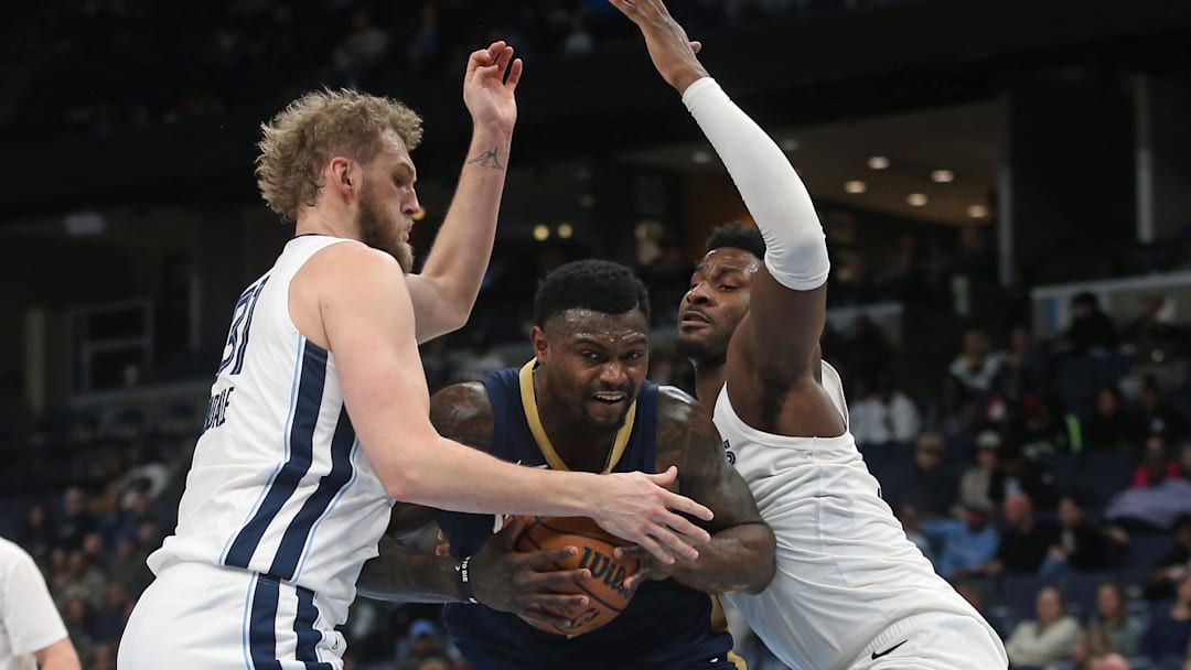 Jan 23, 2026; Memphis, Tennessee, USA; New Orleans Pelicans forward Zion Williamson (1) drives to the basket between Memphis Grizzlies center Jock Landale (31) and forward/center Jaren Jackson Jr. (8) during the second quarter at FedExForum. Mandatory Credit: Petre Thomas-Imagn Images