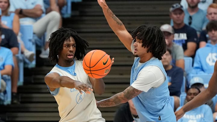 Oct 12, 2024; Chapel Hill, NC, USA; North Carolina Tar Heels guard Ian Jackson (11) passes the ball as North Carolina Tar Heels guard Elliot Cadeau (3) defends in the first half at the Dean E. Smith Center. Mandatory Credit: Bob Donnan-Imagn Images