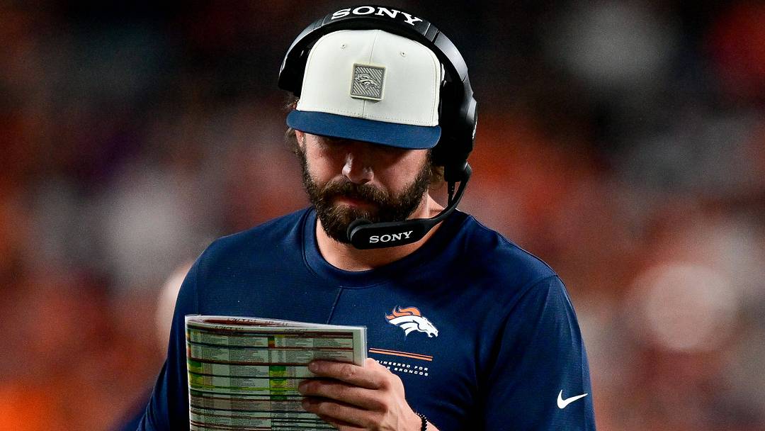 DENVER, CO - AUGUST 28: Denver Broncos offensive coordinator Davis Webb looks at his play sheet. DENVER, CO - AUGUST 28: Denver Broncos offensive coordinator Davis Webb looks at his play sheet.