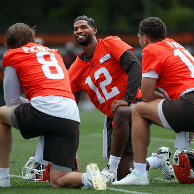 Browns quarterbacks Shedeur Sanders (12), Kenny Pickett (8) and Joe Flacco (15) talk during minicamp June 10, 2025, in Berea,