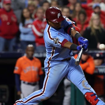 Nov 3, 2022; Philadelphia, Pennsylvania, USA; Philadelphia Phillies second baseman Jean Segura (2) hits a RBI single against the Houston Astros during the eighth inning in game five of the 2022 World Series at Citizens Bank Park.