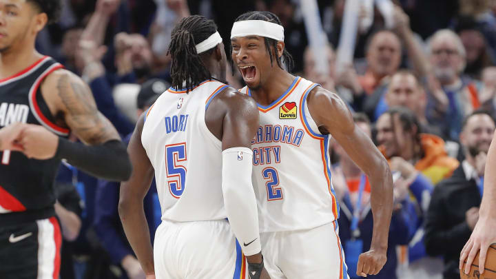 Dec 21, 2022; Oklahoma City, Oklahoma, USA; Oklahoma City Thunder guard Shai Gilgeous-Alexander (2) and Oklahoma City Thunder guard Luguentz Dort (5) celebrate at the end of their game against the Portland Trial Blazers at Paycom Center. Oklahoma City won 101-98. Mandatory Credit: Alonzo Adams-USA TODAY Sports