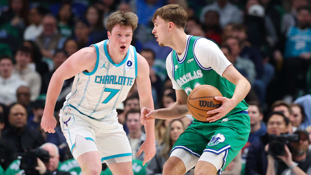 Jan 29, 2026; Dallas, Texas, USA;  Dallas Mavericks forward Cooper Flagg (32) controls the ball as Charlotte Hornets guard Kon Knueppel (7) defends during the first quarter at American Airlines Center. Mandatory Credit: Kevin Jairaj-Imagn Images