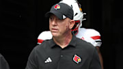 Sep 27, 2025; Pittsburgh, Pennsylvania, USA;  Louisville Cardinals head coach Jeff Brohm leads the team onto the field to play the Pittsburgh Panthers at Acrisure Stadium. Mandatory Credit: Charles LeClaire-Imagn Images