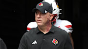 Sep 27, 2025; Pittsburgh, Pennsylvania, USA;  Louisville Cardinals head coach Jeff Brohm leads the team onto the field to play the Pittsburgh Panthers at Acrisure Stadium. Mandatory Credit: Charles LeClaire-Imagn Images
