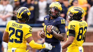 Team Blue Michigan quarterback Bryce Underwood (19) tries to run after recovering his fumble during the second half of the spring game at Michigan Stadium in Ann Arbor on Saturday, April 19, 2025.