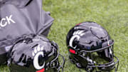 Oct 30, 2021; New Orleans, Louisiana, USA;  Cincinnati Bearcats helmets on the ground during the game against Tulane Green Wave during the second half at Yulman Stadium. Mandatory Credit: Stephen Lew-Imagn Images