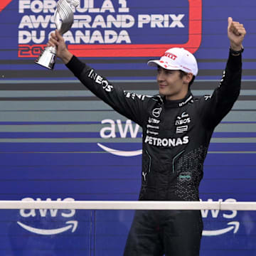 Jun 9, 2024; Montreal, Quebec, CAN;  Mercedes driver George Russell (GBR) reacts next to winner Red Bull Racing driver Max Verstappen (NED) after getting third place in the Canadian Grand Prix at Circuit Gilles Villeneuve. Mandatory Credit: Eric Bolte-Imagn Images