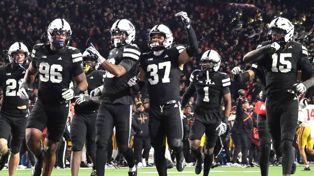 Nebraska players run to the end zone to celebrate Andrew Marshall's interception against USC. Nebraska players run to the end zone to celebrate Andrew Marshall's interception against USC.