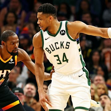 Feb 6, 2024; Phoenix, Arizona, USA; Milwaukee Bucks forward Giannis Antetokounmpo (34) handles the ball against the Phoenix Suns forward Kevin Durant (35) during the third quarter at Footprint Center. Mandatory Credit: Mark J. Rebilas-Imagn Images