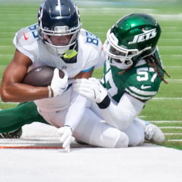 Tennessee Titans wide receiver Tyler Boyd (83) is tackled by New York Jets linebacker C.J. Mosley (57) during their game at Nissan Stadium in Nashville, Tenn., Sunday, Sept. 15, 2024.