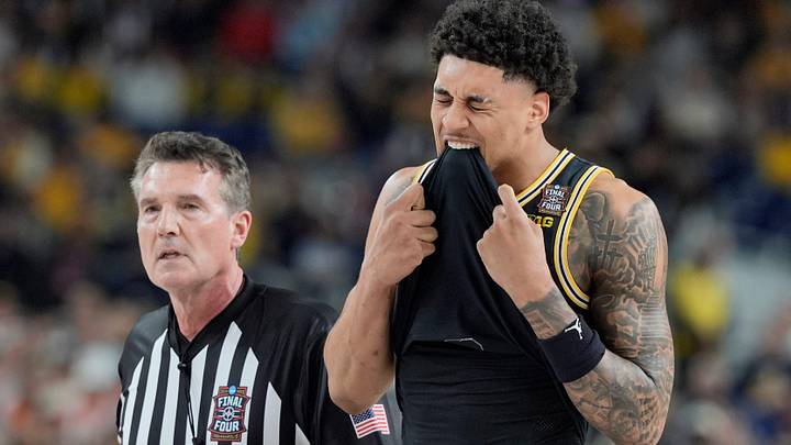 Michigan forward Yaxel Lendeborg (23) bites his jersey following a play in the first half of their Final Four game against Arizona at Lucas Oil Stadium in Indianapolis on Saturday, April 4, 2026.