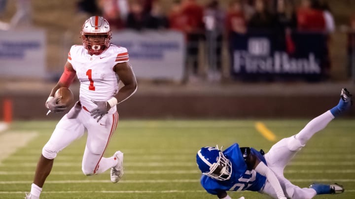 Baylor's Shekai Mills-Knight (1) escapes a tackle attempt by McCallie's De'shun Tipton (20) during the TSSAA BlueCross Bowl Division II-AAA championship game at Finley Stadium in Chattanooga, Tenn. on Thursday, Nov 30, 2023.