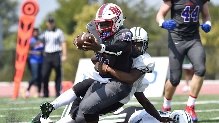 DeMatha Stags quarterback runs the ball into the end zone past Miami Central Rockets