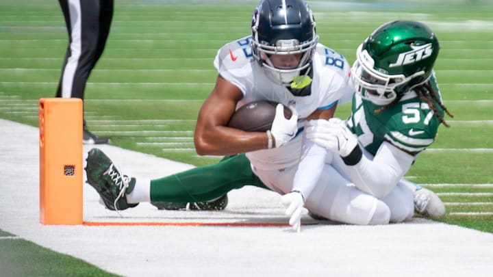 Tennessee Titans wide receiver Tyler Boyd (83) is tackled by New York Jets linebacker C.J. Mosley (57) during their game at Nissan Stadium in Nashville, Tenn., Sunday, Sept. 15, 2024.