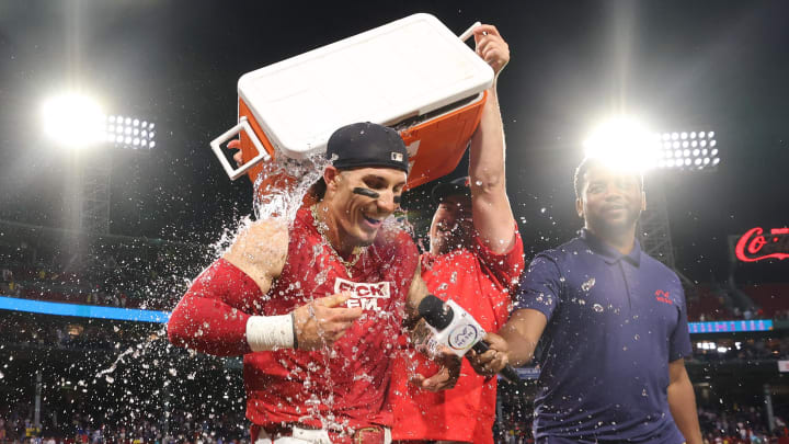 Jun 24, 2024; Boston, Massachusetts, USA; Boston Red Sox left fielder Jarren Duran (16) is dowsed with water after hitting a game winning RBI single against the Toronto Blue Jays at Fenway Park. Mandatory Credit: Paul Rutherford-USA TODAY Sports